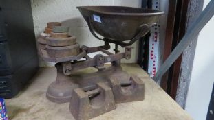A set of vintage shop scales with cast iron weights