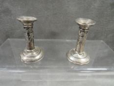 A pair of miniature hallmarked silver Edwardian style candlesticks