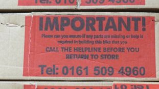 A boxed red Challenge VXT hybrid bike with steel frame, 18 speed, 28