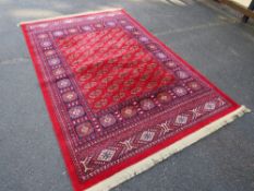 A modern Iranian silk style rug with fringe in red, blue and cream colourway, approx 248 x 156 cm