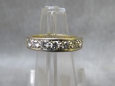 A hallmarked 18ct gold seven stone diamond half eternity ring size P, approximate weight 4.86g