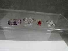 Four dress rings, two marked for silver