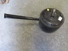 A vintage enamel long handled stone cooking pot