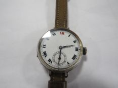 An antique trench watch, large size silver case hallmarked Glasgow