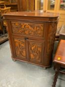 An Eastern carved drinks cabinet