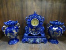 A ceramic Oriental themed clock garniture
