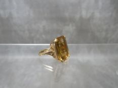 A HALLMARKED 9CT GOLD GEMSET DRESS RING, set with a large emerald cut citrine, ring size L,