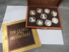 A boxed set of nine sterling silver medals for the Queens of the British Isles issued by the