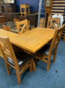 A quality light oak extending dining table with four chairs