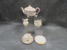 A Belleek seashell teapot, cream jug, cup and saucer, additional saucer and another small cream