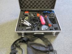 A cased Go Pro and accessories
