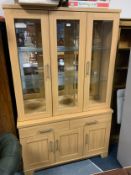 A modern light oak effect display cabinet/bookcase
