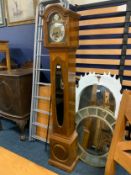 An 8 day Haller Westminster chime Grandmother clock, the slender blonde oak case with oval