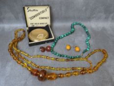 A vintage single strand graduated malachite beads, together with a selection of vintage amber