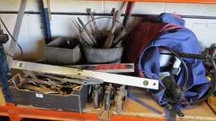 A large selection of hand tools together with a crop sprayer