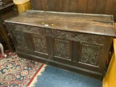An antique oak carved four panel coffer W 140 cm