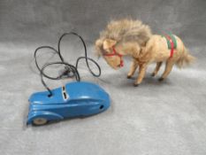 A vintage Schuco telesteering tinplate car together with a wind up horse, both items A/F