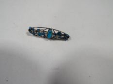 A Victorian Art Nouveau brooch with turquoise and enamel