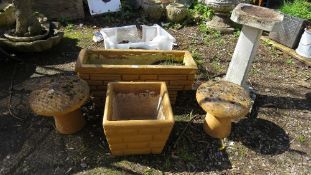 A selection of concrete garden ornaments to include a bird bath, planters and mushrooms