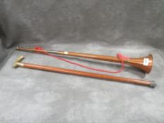 A copper horn together with a walking stick