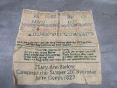 An antique sampler dated 1823