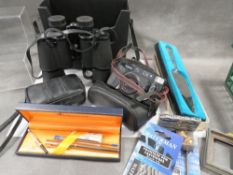 A tray of assorted collectables to include a hallmarked silver handled cake slice, binoculars etc