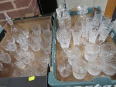 Two trays of assorted glassware to include drinking glasses and decanters etc