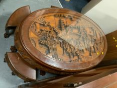 An Eastern carved glass topped oval nest of tables with eight smaller tables beneath