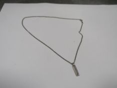 A hallmarked silver ingot and chain