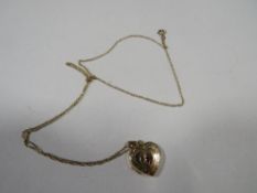 A hallmarked 9 carat gold gem set locket on a chain stamped 9k approx combined weight 2g