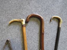 A collection of vintage walking sticks etc