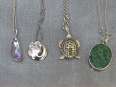 A collection of silver and white metal pendants and chains (4)