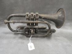 A vintage metal cornet with inscription