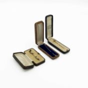 A 15ct stick pin set with aquamarine and seed pearl, a gold pink paste pin and one other pin.