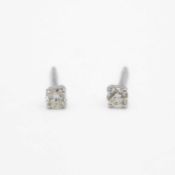 A pair of 18k white gold diamond solitaire stud earrings.