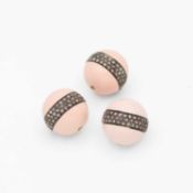 A set of three silver powder pink enamel beads each with a band of diamonds.