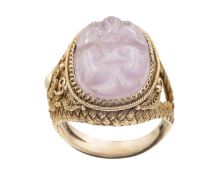 A Chinese carved amethyst in a silver gilt adjustable ring.