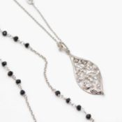 A silver leaf-shaped pendant necklace, and a long silver black glass bead necklace with cross.