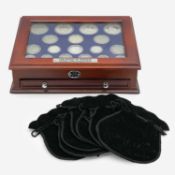 The House of Windsor Silver Coin Collection by Danbury Mint, in deluxe wooden collector's cabinet.