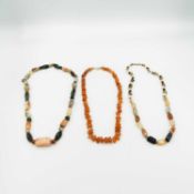 A Carnelian bead necklace and two hard-stone bead necklaces.