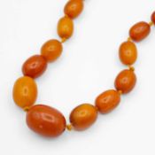 A butterscotch amber-style graduated bead necklace.