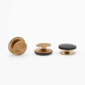 A cased set of three gold (tests 9k) and black enamel dress shirt buttons.
