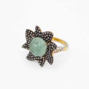 A silver-gilt ring set with a carved aquamarine and rose-cut diamonds.