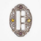 An Edwardian silver Celtic knot design buckle set with amethyst and citrine by Lawrence Emanuel.