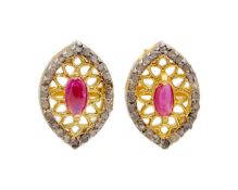 A pair of silver gilt, ruby, and diamond stud earrings.