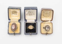 An Arts & Crafts rose quartz set silver ring, a carnelian set silver ring and a base signet ring.