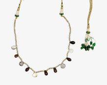 An Indian necklace set with briolette cut mixed quartz beads, on a metal thread cord with seed pearl