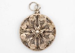 A silver filigree pendant.