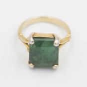 A silver-gilt cocktail ring, set with a large emerald.