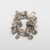 A silver charm bracelet with a good selection of silver and white metal charms.
